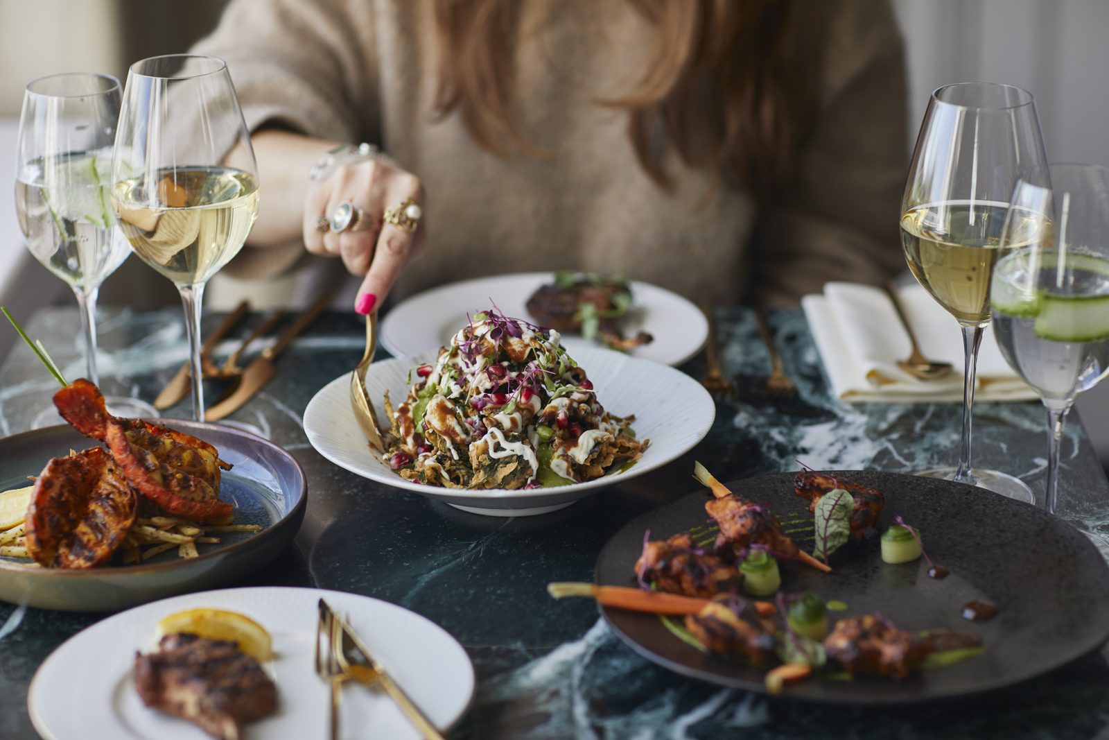 Sharing dishes and wine at a Madhu's table